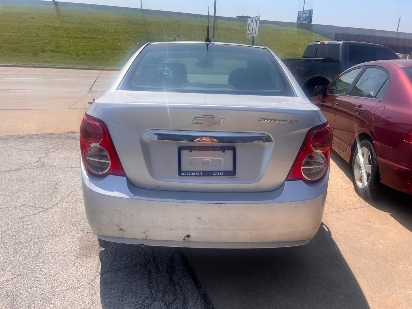 2013 SILVER CHEVROLET SONIC LT LT Auto Sedan (1G1JC5SHXD4) with an 1.8L L4 DOHC 24V FFV engine, 6-Speed Automatic transmission, located at 8101 E. Skelly Dr., Tulsa, OK, 74129, (918) 592-3593, 36.121891, -95.888802 - Photo#4